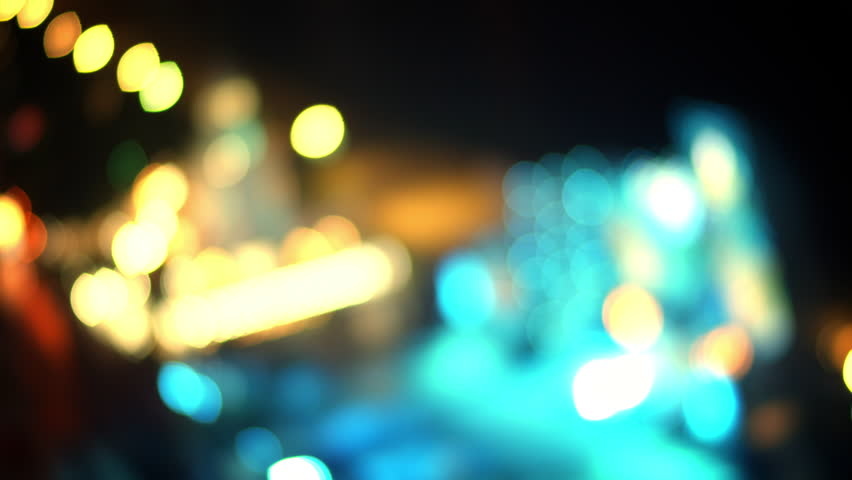 Lights on street at midnight, Abstract light background particles.Movement flow multi-colored rays. Abstraction of rays in white-blue yellow-red color neon light is reshaped through a glass prism. 4K Royalty-Free Stock Footage #1105180261