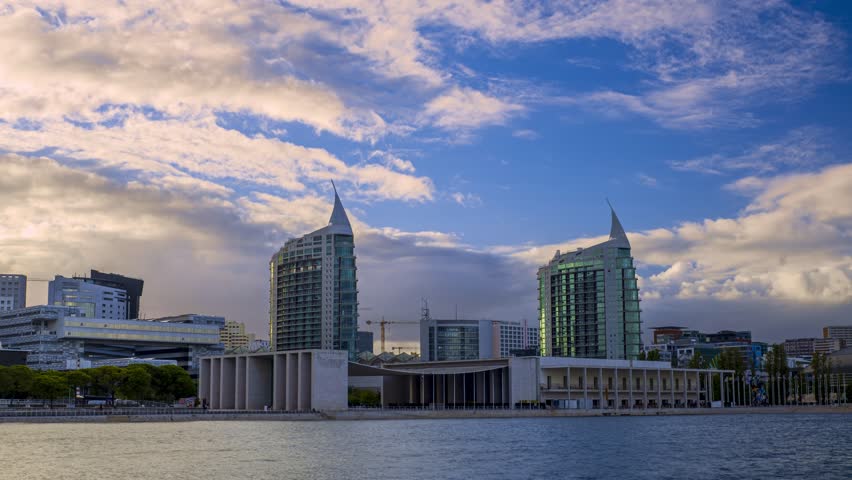 Clouds fly over twin buildings in Park of Nations, Lisbon, Portugal. Modern residential area and downtown on sunny day. 