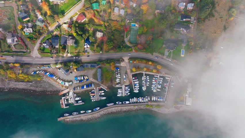 Aerial Birds Eye View Of Boat Marina Beside Lake Moreno Near San Carlos de Bariloche With Clouds Coming Into View From Left hand Side