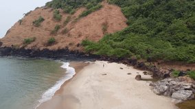 girl photographer on a wild beach makes photos, aerial photography