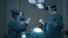 Two medical man and woman wearing VR virtual reality goggles talking and discuss for treatment critically ill patient on bed in operating room. Metaverse technology concept, Futuristic lifestyle