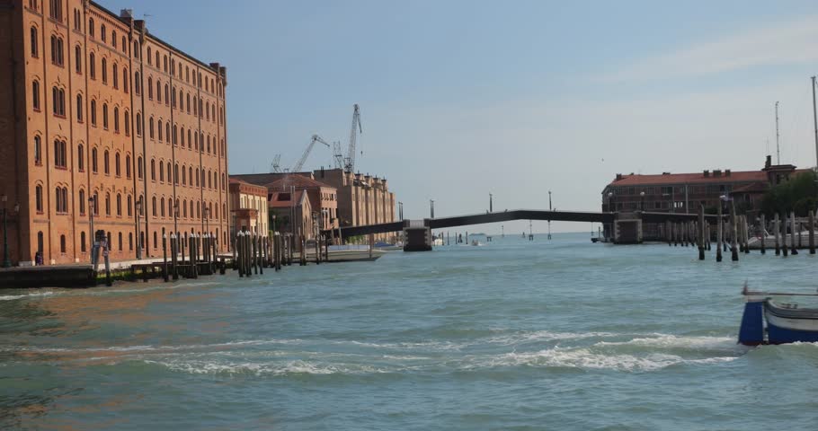 View from the ship board, bridge over the canal, bricoles and paline in Venetian Lagoon, Italy. Venice, Italy.