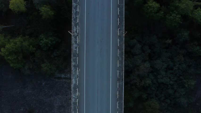 Dark scenery of empty, unfinished bridge construction in the middle of nowhere.