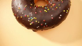 In a captivating macro video, indulge your senses with the mesmerizing beauty of rich, chocolate-brown donuts. Delicate textures and mouthwatering details will leave you craving every delectable bite
 - Powered by Shutterstock - Get 15% off with code: PIKWIZARD15