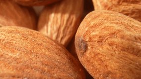 The macro video offers a visual exploration of almond kernels. It celebrates the natural elegance and complexity of these small, nutritious wonders. Food and snack concepts. Almond background. 4K
