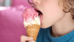Closeup portrait of cute boy eating waffles cone ice cream. Child licking ice cream. - Powered by Shutterstock - Get 15% off with code: PIKWIZARD15