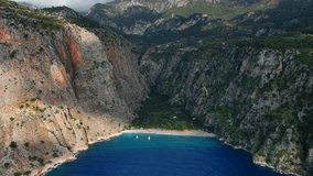 This hyperlapse drone video provides an accelerated aerial view of Butterfly Valley in Ölüdeniz. Highlighting the bay and surrounding cliffs.