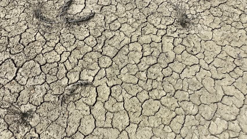 Looking down at the cracked surface of a dry river Royalty-Free Stock Footage #1105212555