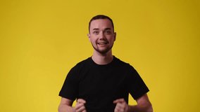 4k video of one man who supporting someone over yellow background.