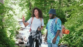 Couple young man and woman making selfie in hike in wild forest for social media. Taking photo and video from trip. Family, journey, trekking, travel, tourism concept. Summer vacations in mountain.