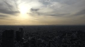 TOKYO, JAPAN : Aerial sunset view of CITYSCAPE of TOKYO and MOUNT FUJI. Buildings around Shibuya station. Time lapse shot, dusk to night. Japanese urban city life and metropolis concept, 4K video.