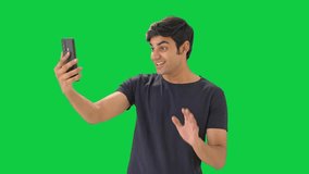 Happy Indian boy talking on video call Green screen