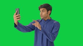 Angry Indian man shouting on video call Green screen