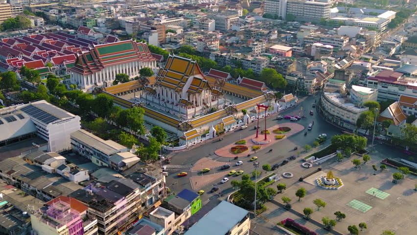Aerial top view of Giant Swing or Sao Ching Cha monument with Wat Suthat temple at sunset in old town, Bangkok City, Thailand. Landmark tourist attraction. Thai architecture with travel trip concept.