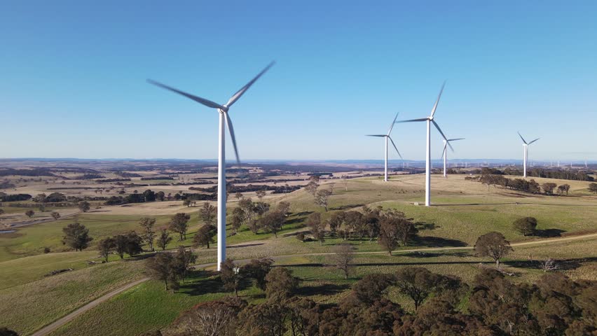 Aerial drone flypast of large wind turbines at a wind farm near Bannister in the Southern Tablelands region of New South Wales, Australia Royalty-Free Stock Footage #1105221975