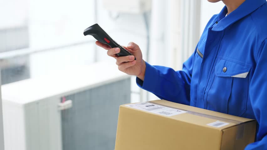 Asian male worker using a bar code reader with a cardboard. Delivery staff. Royalty-Free Stock Footage #1105224995