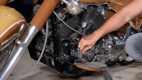 A mechanic repairs a motorcycle at a service station. Beautiful motorcycle - Powered by Shutterstock - Get 15% off with code: PIKWIZARD15