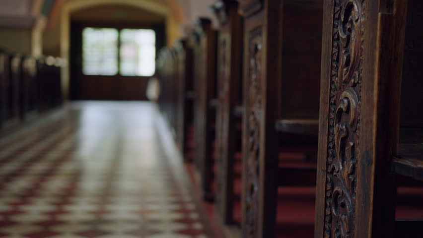 Close-up of wooden church pews. Interior of the Catholic church