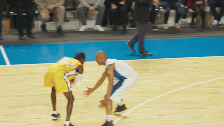 Basketball Championship Tracking Footage: Yellow Team Passing the Ball Between Teammates, Forward Player Scoring a Two-Point Goal From a Distance. Sport TV Channel Broadcast Playback