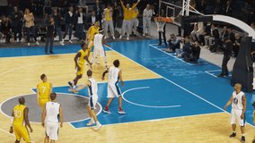 Basketball Championship Game: Yellow Team Shoots a Perfect Free-Throw Line Goal, Takes the Lead, Players Celebrate with Hugs and Chest Bumps. Joyful Sports Playback Action on Live TV Broadcast - Powered by Shutterstock - Get 15% off with code: PIKWIZARD15