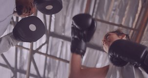 Animation of world map over diverse man and woman exercising in boxing gym. Sports, competition and fitness concept digitally generated video.