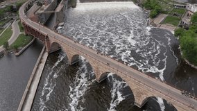 Bird's eye aerial shot flying over Saint Anthony Falls on the Mississippi River in downtown Minneapolis, Minnesota. 4K - Powered by Shutterstock - Get 15% off with code: PIKWIZARD15