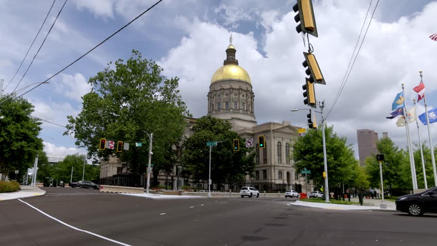 Georgia state capitol building in Atlanta, Georgia with cars driving by stable video.