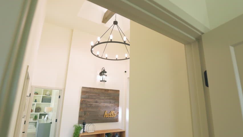 Look Up at Main Light Fixture Tilt Down Entryway. slow motion view walking through doorway looking up at main entrance light fixture tilt down to main entrance Royalty-Free Stock Footage #1105244593