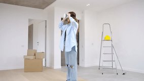 Young modern caucasian female wearing VR headset using augmented reality technologies to redesign apartment