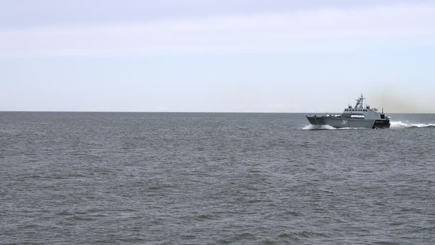 Russian warships sails on sea ready for attack by enemy, armed military ships of russian navy floating in sea by order of military officer of Russia, large frightening warships cut through sea waves