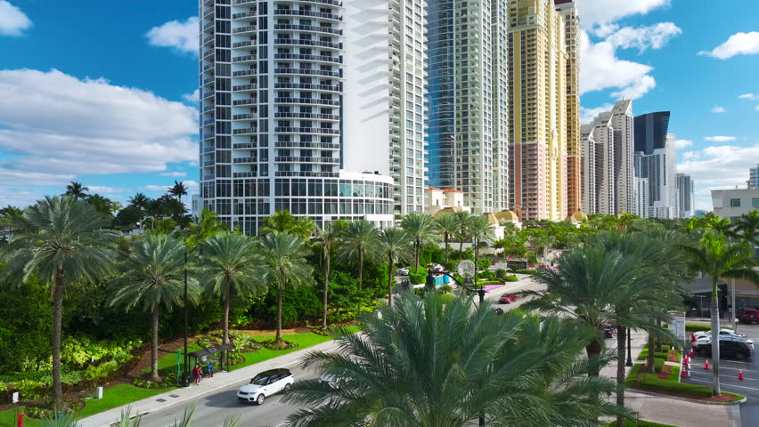 Aerial view of Sunny Isles Beach city with congested street traffic and luxurious highrise hotels and condos on Atlantic ocean shore. American tourism infrastructure in southern Florida