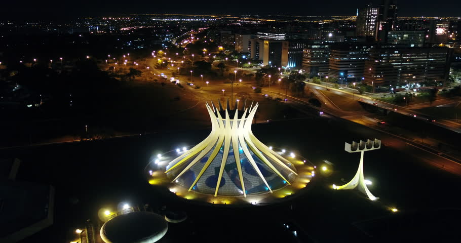 Metropolitan Cathedral Nossa Senhora Aparecida Brasilia Federal District Brazil - 05 25 2021: Night aerial view of the Cathedral of Brasilia all lit up with the movement of cars. illuminated city.  Royalty-Free Stock Footage #1105249111