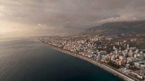 Aerial Marvel: Cinematic Drone Films the Breathtaking Sunset in Bedtime Hues Above the Sea