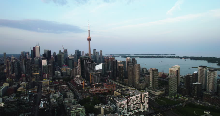 Flying away from downtown Toronto, sunset in Canada - pull back, drone shot