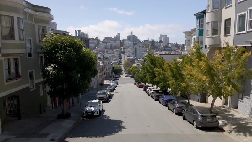 Captivating drone footage rises above Little Italy in San Francisco, CA, maintaining a one-point perspective with the road lines guiding the viewer deeper into this vibrant neighborhood