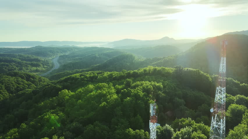 5G telecom tower in green forest with planet earth animation for environmental sustainable development. Aerial view at sunset drone above telecommunication base station Royalty-Free Stock Footage #1105254421