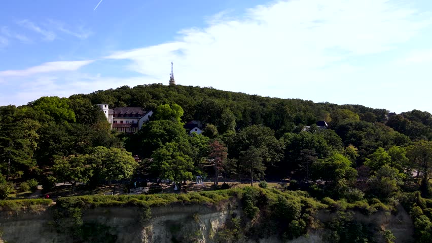 Luxury buildings among trees on bluff over Lake Balaton, Fonyod, Hungary, aerial.