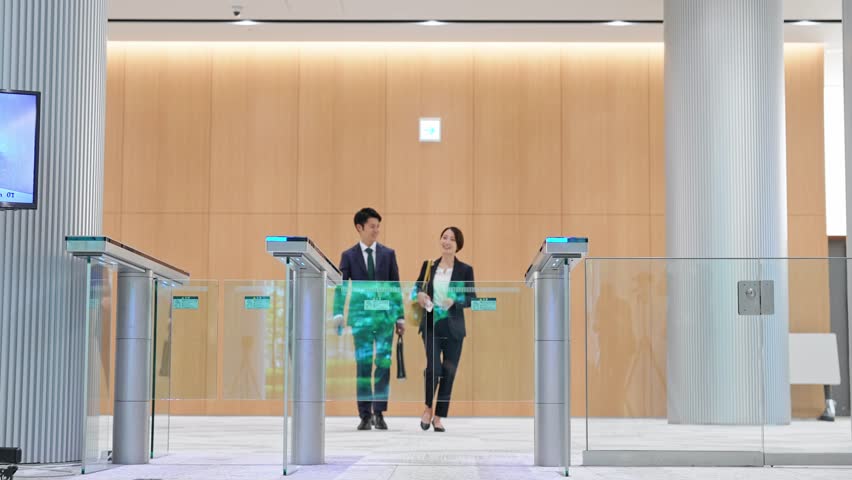 Group of people pass through the office entrance gate after ID card authentication. Royalty-Free Stock Footage #1105258897