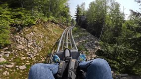 Revelstoke Roller Coaster in mountains with forest. male rides on the Revelstoke, summer attraction in mountain ride. Entertainment and recreation concept - Powered by Shutterstock - Get 15% off with code: PIKWIZARD15