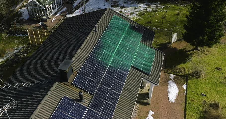 Aerial view of electricity flowing through rooftop solar panels to the inverter - motion graphics Royalty-Free Stock Footage #1105266463