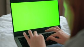 Close up smart caucasian teenage girl female hands using laptop green blank screen Chroma Key. Woman typing on the keyboard using touchscreen. Online shopping, browsing internet, messaging, social
