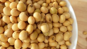 Macro footage of exquisite soybeans in a bowl, showcasing their beauty up close. Delve into the intricate details and vibrant colors in this captivating video. Soybeans background. 4K HDR
