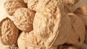 Incredible close-up shots unveil the hidden beauty of walnuts, as their jagged contours and intricate veining take center stage. Grain and food concept. Walnuts background. 4K
