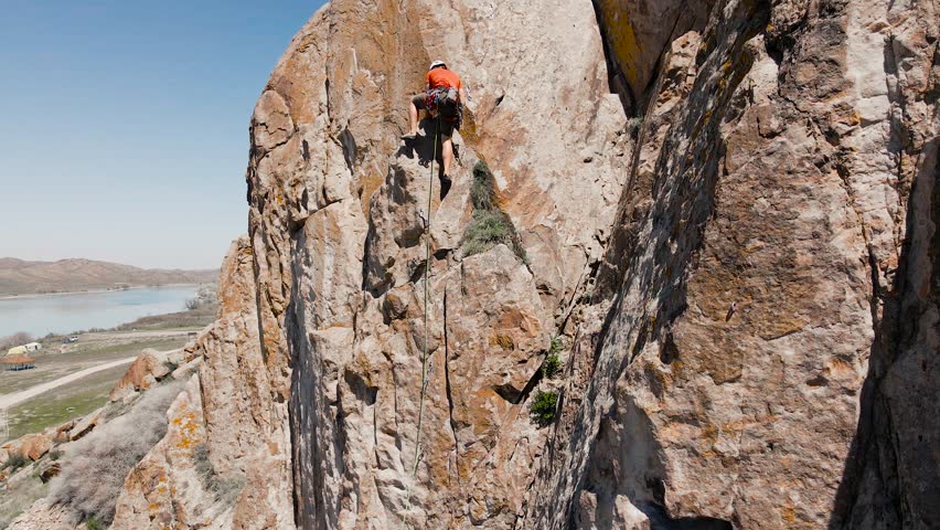 Man athlette climbing on the high rock
