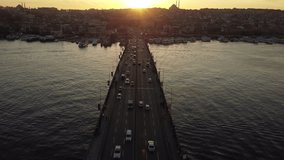 Wide aerial view of the highway passing through the Bosphorus Bridge. Smooth drone flight in Istanbul during sunset. Freeway road in the Turkish metropolis. 4k footage.