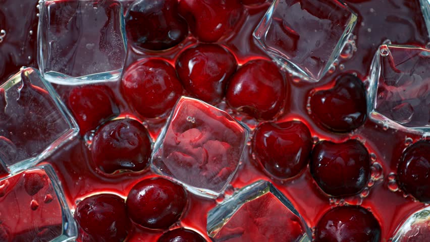 Super Slow Motion Shot of Water Wave Splashing on Cherries and Ice Cubes at 1000fps. Royalty-Free Stock Footage #1105281595