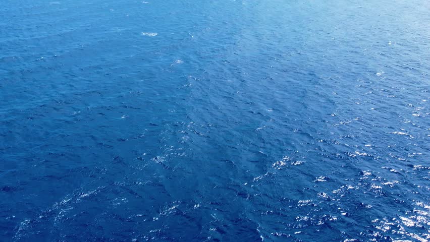 Tropical blue water of Caribbean Sea ocean sunny beautifu waters. Flying drone arial shot rocky and sandy beaches and beautiful waves. Perfect holiday travel exotic destination Curacao Aruba Bonaire