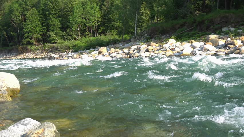 river rapids mountain stream in flood - rafting and canoeing in Alagna Val Sesia Piedmont Italy Alps Europe - thawing of glaciers and increase in the water level of rivers with the danger of flooding 