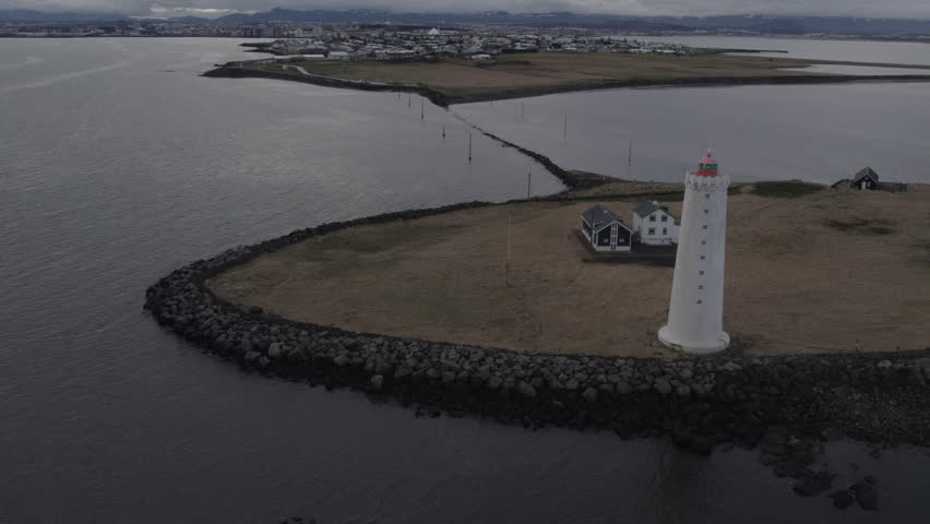 Nice aerial shot going over the Grotta lighthouse on a cloudy day. In Iceland.