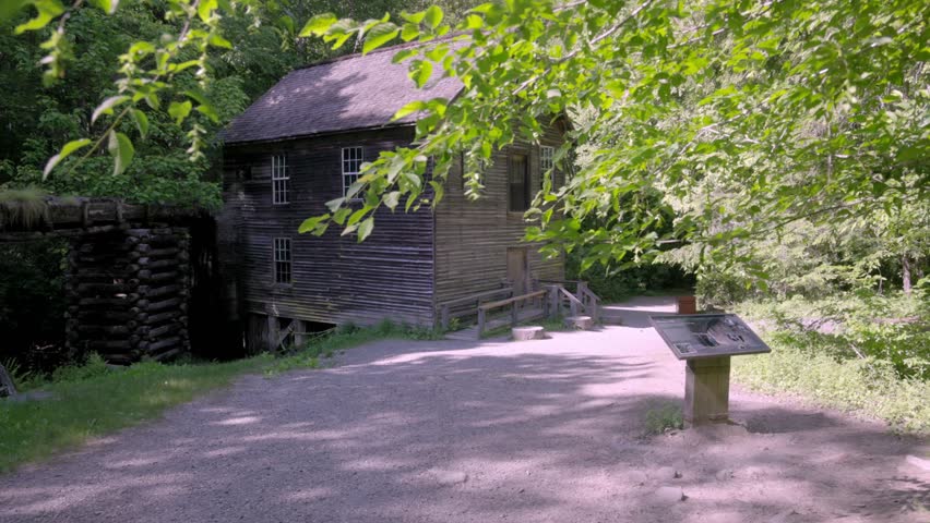 Mingus Mill in the Great Smoky Mountains National Park with gimbal video walking forward with trees wide shot.